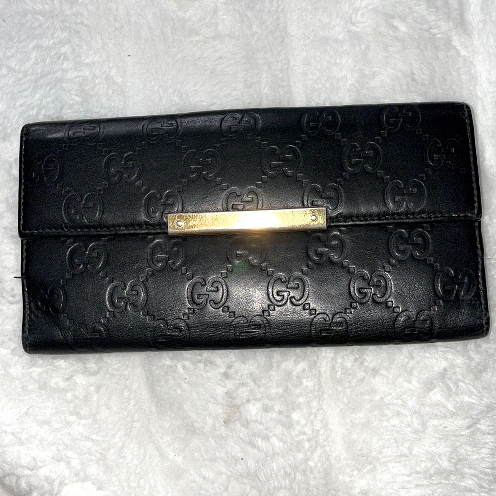 Black Gucci Guccissima wallet with gold hardware